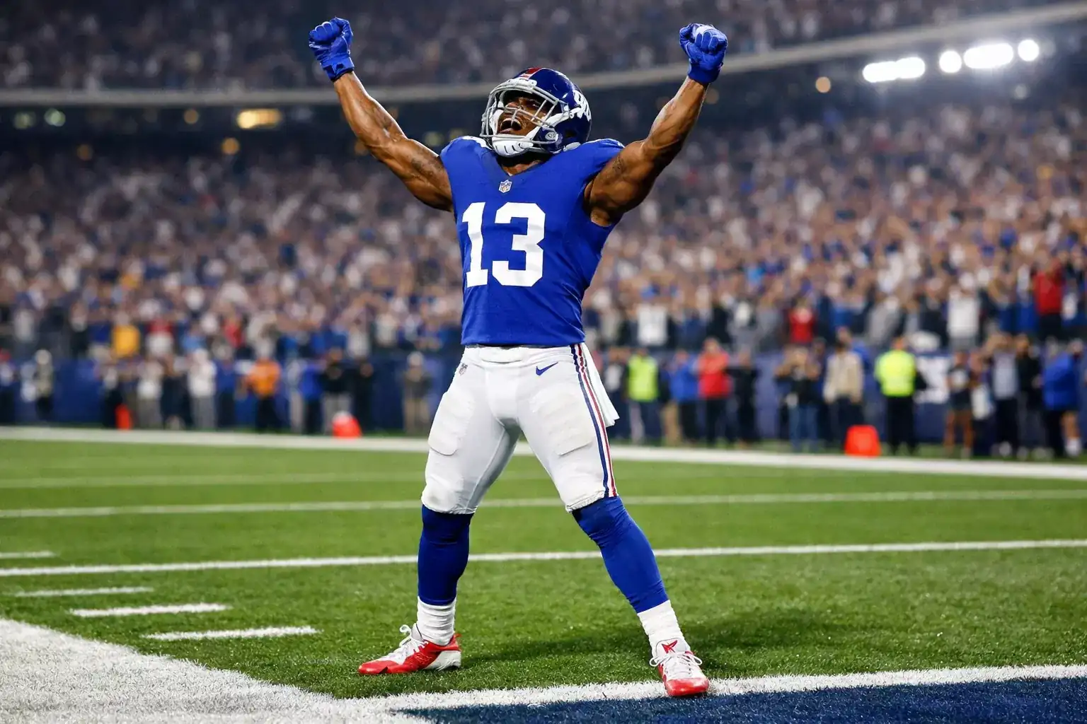 NFL wide receiver celebrating touchdown catch in end zone