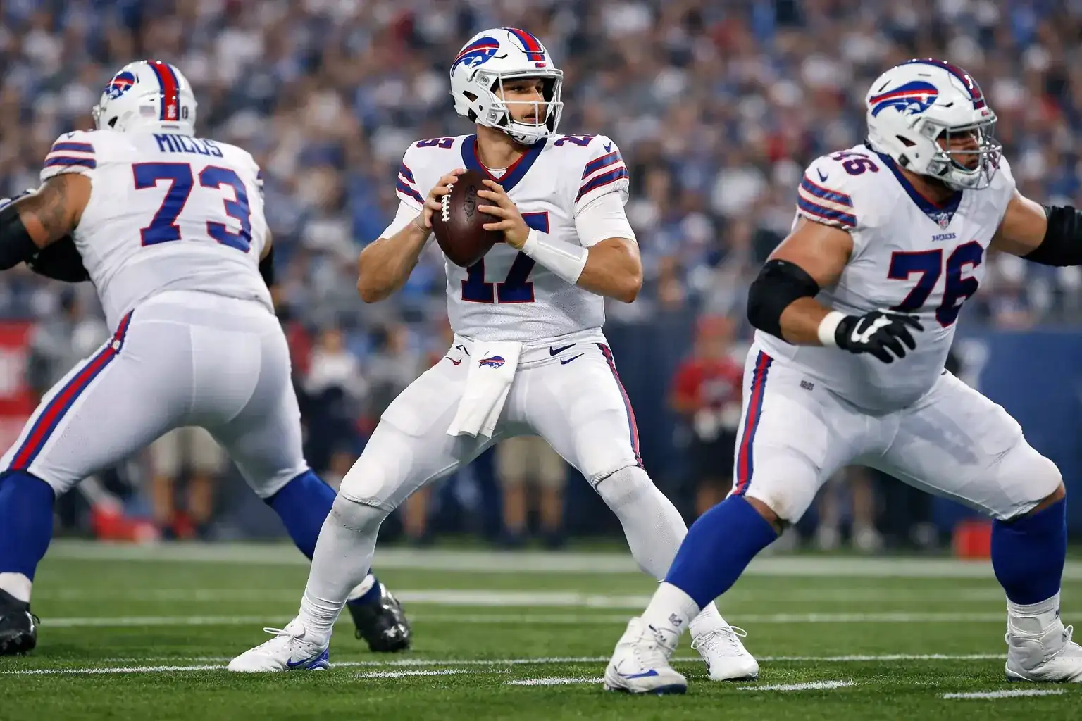 NFL quarterback in pocket looking downfield to throw football
